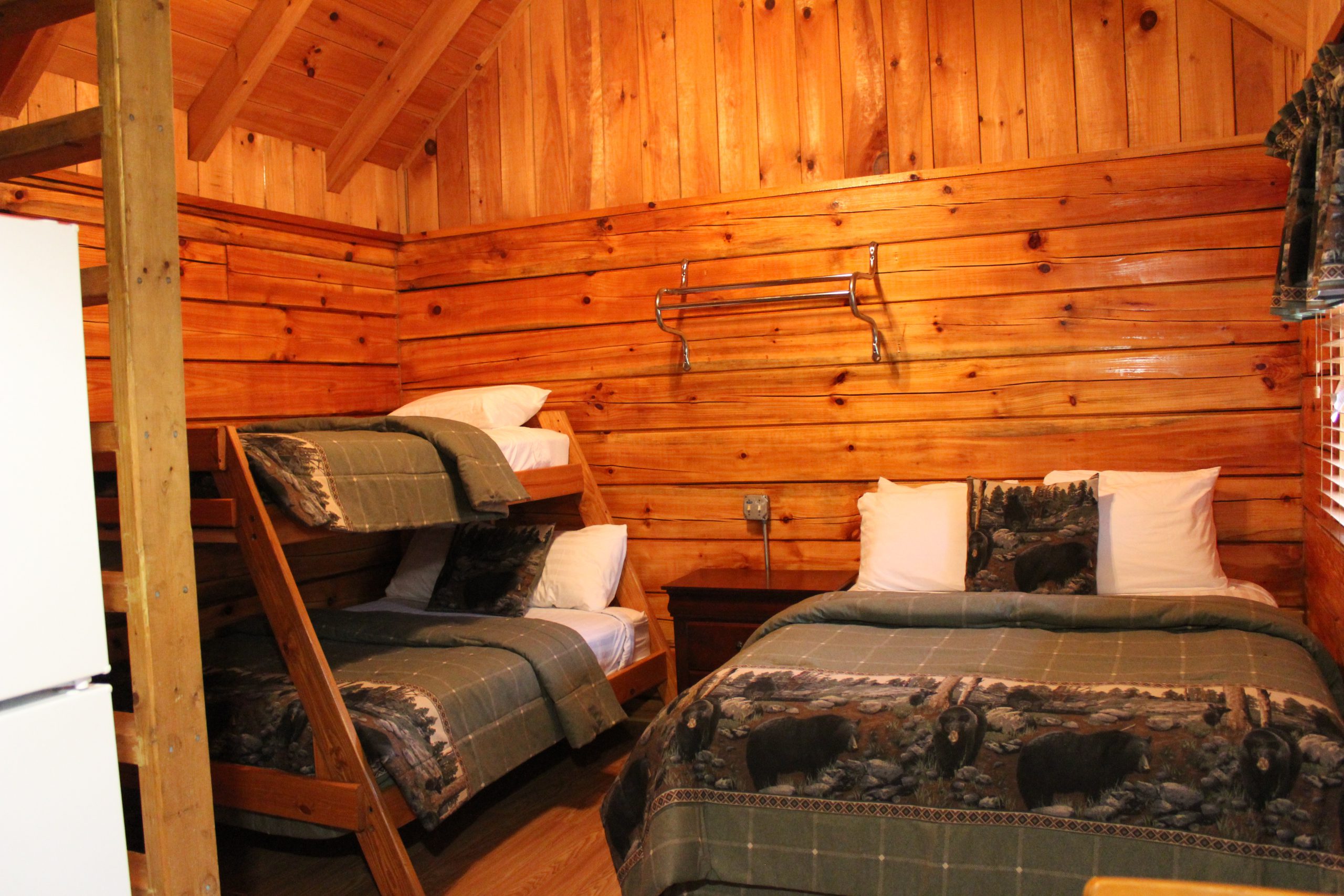 cabin bedroom with queen bed and bunk bed